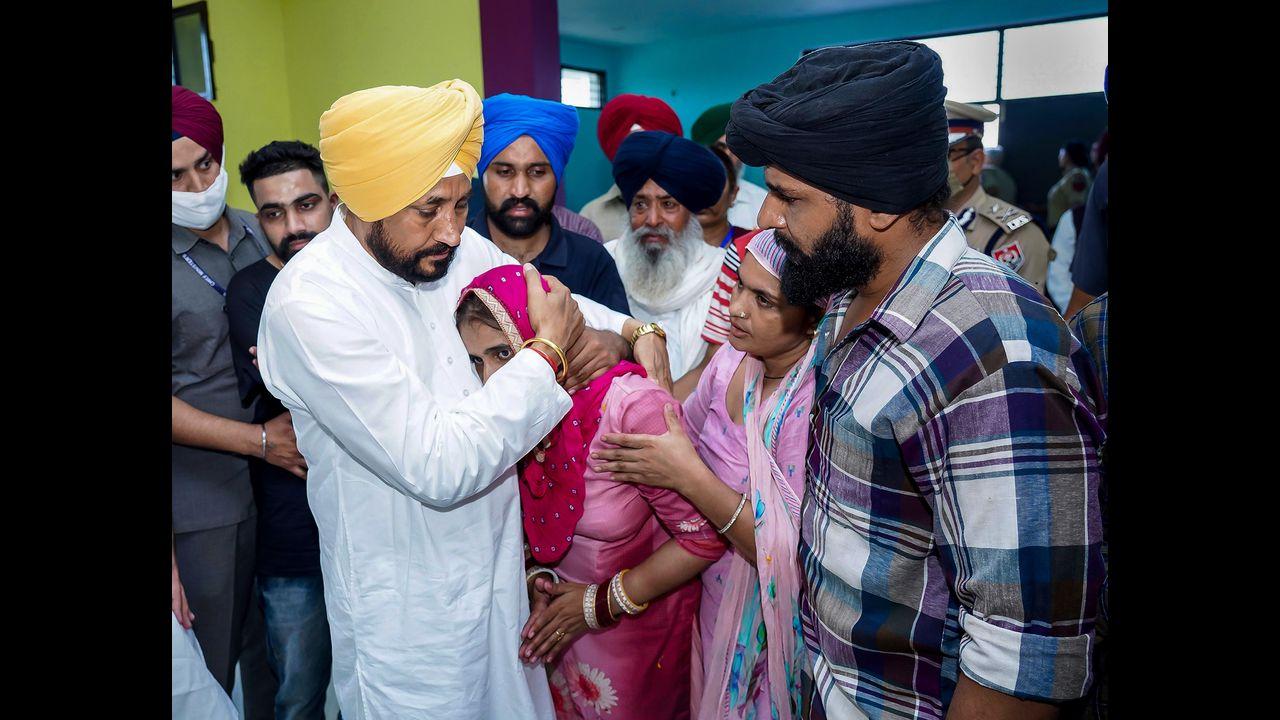 Punjab Chief Minister Charanjit Singh Channi consoles a family member of martyr Sepoy Gajjan Singh during his funeral. Pic/PTI